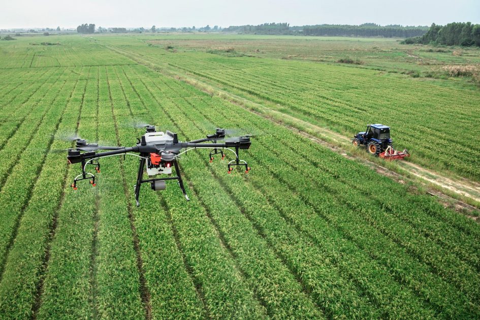 Photo about drone, fields and tractor.