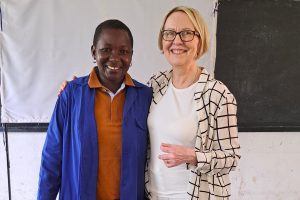 Photo of two people smiling at the camera.